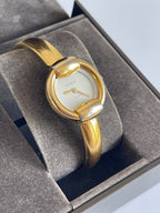 MODEVESTIGE vintage Gucci 1400L gold-plated bangle watch with a white dial, presented in a branded display box.